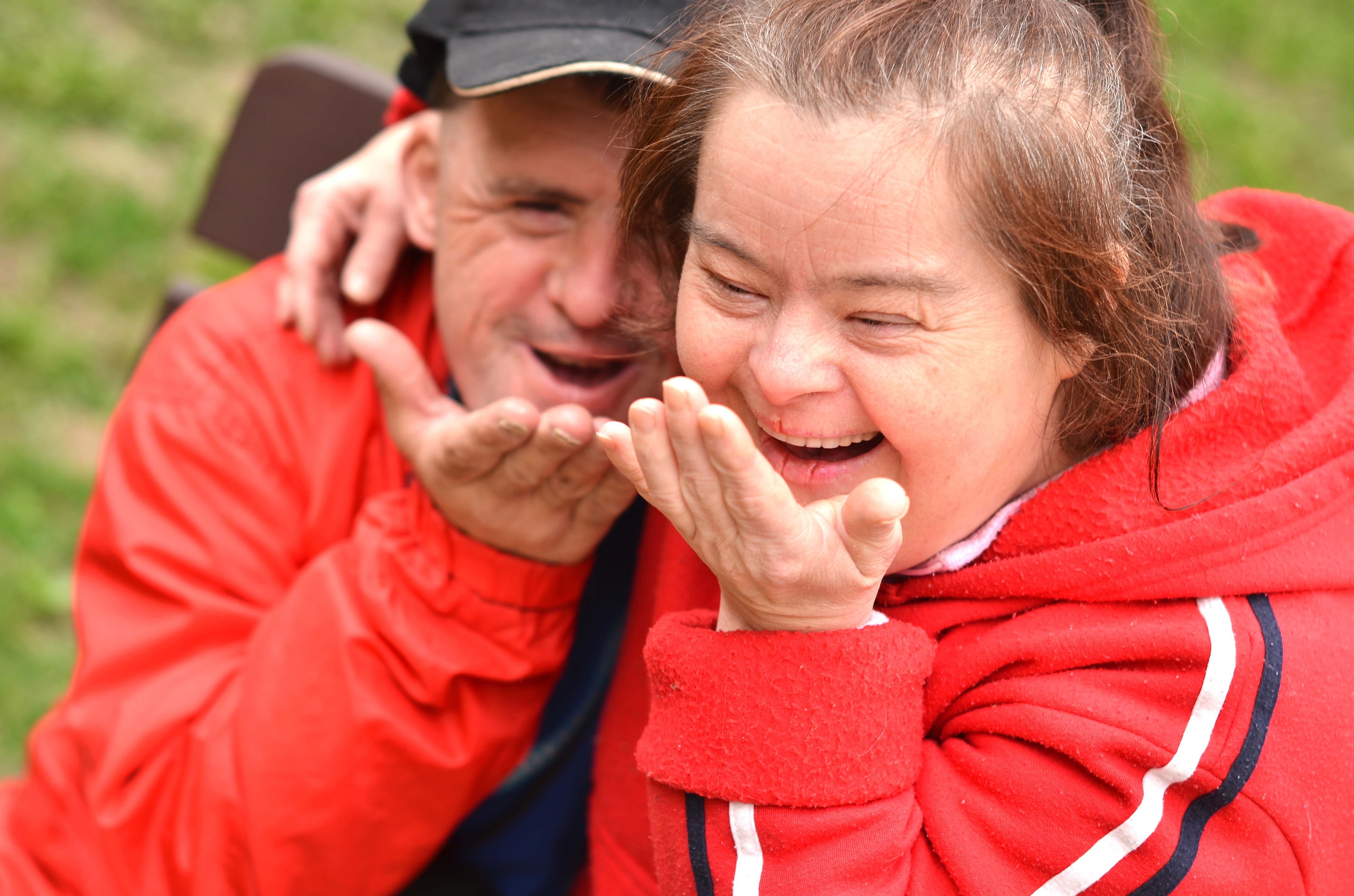 Two adults laugh together