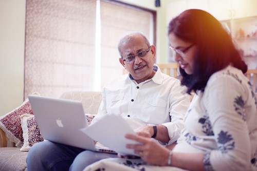 Two people look at a document together