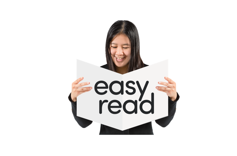 A woman holding an easy read booklet.
